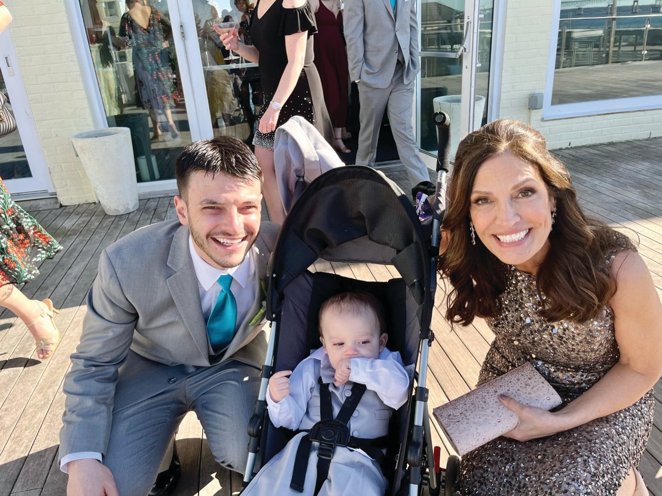 Groom Bryan Schnell shares a moment before the ceremony with his mother, Jana Schnell, and Jace, his infant son. Jace was born between Bryan and Caitlin’s 2020 and 2022 weddings.